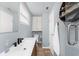Stylish bathroom with modern vanity, neutral tiling, and a convenient window for natural light at 2191 Williamsburg Way, Englewood, FL 34224