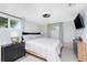 Comfortable bedroom featuring natural light, simple decor, and a ceiling fan fixture for a modern touch at 2191 Williamsburg Way, Englewood, FL 34224