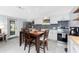 Bright kitchen featuring modern appliances, white cabinets, and a central dining table with seating at 2191 Williamsburg Way, Englewood, FL 34224