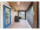 Enclosed laundry area featuring wood paneled ceilings and screened porch access at 2191 Williamsburg Way, Englewood, FL 34224