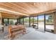 Spacious, versatile patio with natural wood accents, large sliding doors, and outdoor dining at 2191 Williamsburg Way, Englewood, FL 34224