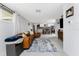 Open-concept living area flows into a kitchen and dining space, featuring modern décor and tiled floors at 2191 Williamsburg Way, Englewood, FL 34224
