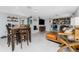 Spacious living area connects to a dining space, enhanced by natural light and modern decor at 2191 Williamsburg Way, Englewood, FL 34224