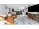 This open-concept living room flows into a kitchen with white cabinets, stainless appliances, and a cozy dining area at 2191 Williamsburg Way, Englewood, FL 34224