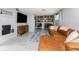 Comfortable living room featuring a leather sectional sofa, fireplace, and shelving in a modern aesthetic at 2191 Williamsburg Way, Englewood, FL 34224