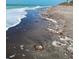 Seascape view of the coastline with foamy waves reaching the sandy beach at 2545 Geneva Rd, Venice, FL 34293