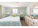 Comfortable bedroom features a queen-sized bed, side tables with lamps, and natural light from large windows at 2545 Geneva Rd, Venice, FL 34293