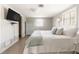 Bright bedroom features a comfortable bed, TV, and a closet with a view to the ensuite bath at 2545 Geneva Rd, Venice, FL 34293
