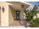 Welcoming front entrance with tiled porch, decorative columns, and a stylish glass-paneled front door for a grand entry at 2545 Geneva Rd, Venice, FL 34293