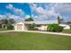 Charming single-story home with well-maintained lawn, mature landscaping, and a two-car garage at 2545 Geneva Rd, Venice, FL 34293