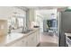 Bright kitchen featuring stainless steel appliances, a double sink, and an open layout to the dining area at 2545 Geneva Rd, Venice, FL 34293