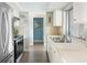 Bright kitchen with stainless steel appliances, tile countertops, and plenty of natural light for enjoyable cooking at 2545 Geneva Rd, Venice, FL 34293