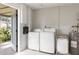 Functional laundry room with washer, dryer, and ample storage space at 2545 Geneva Rd, Venice, FL 34293