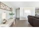 Inviting living room featuring stylish decor, light walls, wood-look floors, and ample natural light at 2545 Geneva Rd, Venice, FL 34293