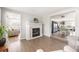Living room boasts wood floors, a decorative fireplace, and an open view to the adjacent dining area at 2545 Geneva Rd, Venice, FL 34293