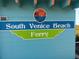 The South Venice Beach Ferry signage with beach themed logo above at 2545 Geneva Rd, Venice, FL 34293