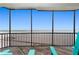 Relaxing balcony featuring beach views and comfortable Adirondack chairs at 2820 N Beach Rd # 101, Englewood, FL 34223