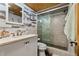 This bathroom features a glass shower, a modern sink, and coastal decor for a stylish and functional space at 2820 N Beach Rd # 101, Englewood, FL 34223