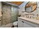 Bathroom featuring a glass shower, a modern sink, and decor, combining style with functionality at 2820 N Beach Rd # 101, Englewood, FL 34223
