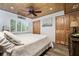Bedroom with wood-paneled ceiling, ample natural light, and spacious closets offer a tranquil retreat at 2820 N Beach Rd # 101, Englewood, FL 34223