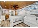Bright bedroom with white furniture, wood-paneled ceiling, and coastal decor, offering a relaxing retreat at 2820 N Beach Rd # 101, Englewood, FL 34223