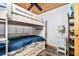 Bedroom with wood-paneled ceiling has cozy bunk beds and a serene space for rest and relaxation at 2820 N Beach Rd # 101, Englewood, FL 34223