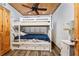 Bedroom with wood-paneled ceiling offers cozy bunk beds and a serene space for rest and relaxation at 2820 N Beach Rd # 101, Englewood, FL 34223