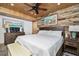 Warm bedroom features wood paneling, a dark wood headboard, and a cozy feel perfect for relaxation at 2820 N Beach Rd # 101, Englewood, FL 34223