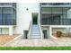 Condo building entrance featuring well-maintained stairs providing access to the units in a beachfront community at 2820 N Beach Rd # 101, Englewood, FL 34223