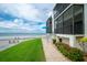 Landscaped condo exterior with inviting walkway, offering easy access to the beach and showcasing coastal living at its finest at 2820 N Beach Rd # 101, Englewood, FL 34223