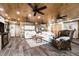 Spacious living room with wood accents, ceiling fans, and comfortable seating at 2820 N Beach Rd # 101, Englewood, FL 34223