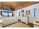 Cozy bedroom featuring ocean views, nautical decor, and shuttered windows at 2820 N Beach Rd # 101, Englewood, FL 34223
