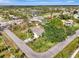 Aerial view of a home on a corner lot near a lake in a quiet residential neighborhood at 35 Michigan Ave, Englewood, FL 34223