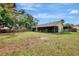 Large grassy backyard is fenced and features a screened porch, perfect for outdoor living at 35 Michigan Ave, Englewood, FL 34223