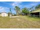 Expansive backyard features mature trees, an outbuilding, and plenty of space for activities at 35 Michigan Ave, Englewood, FL 34223