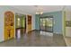 Spacious dining room with polished floors, built-in display cabinet, and outdoor access at 35 Michigan Ave, Englewood, FL 34223