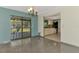Open-concept dining area features stylish lighting and sliding glass doors to backyard at 35 Michigan Ave, Englewood, FL 34223