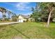 Single-story home with lush front lawn and mature trees in a desirable location at 35 Michigan Ave, Englewood, FL 34223