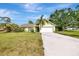 Charming single-story home features a well-manicured lawn and a long concrete driveway at 35 Michigan Ave, Englewood, FL 34223