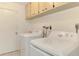 A dedicated laundry room with appliances and storage at 35 Michigan Ave, Englewood, FL 34223