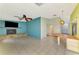 Open living room with a brick fireplace and ample natural light at 35 Michigan Ave, Englewood, FL 34223
