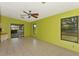 Open living room with tile flooring, ceiling fan, and sliding glass doors to the exterior at 35 Michigan Ave, Englewood, FL 34223