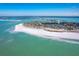 Breathtaking aerial view of coastal homes nestled along a pristine beach with turquoise waters at 36 Seawatch Dr, Boca Grande, FL 33921