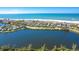 Aerial view of the property with the home highlighted, showcasing its location near a lake at 36 Seawatch Dr, Boca Grande, FL 33921