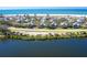 Aerial view of the property with the home highlighted, showcasing its location near a lake at 36 Seawatch Dr, Boca Grande, FL 33921