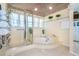 Bright bathroom with a jacuzzi tub, glass shower, and tiled floors at 36 Seawatch Dr, Boca Grande, FL 33921