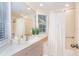Bathroom featuring a wide mirror, window, and a shower with a curtain at 36 Seawatch Dr, Boca Grande, FL 33921