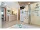 Spacious bathroom with double sink vanity, jacuzzi tub, glass shower and tiled floors at 36 Seawatch Dr, Boca Grande, FL 33921