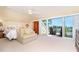 Bright bedroom with a sitting area, walkout access, and lovely water view at 36 Seawatch Dr, Boca Grande, FL 33921
