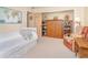 Spacious bedroom with a white bed, a comfortable chair, and built-in storage at 36 Seawatch Dr, Boca Grande, FL 33921